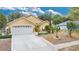 Inviting home with a well-manicured front yard, a two-car garage, and vibrant landscaping at 906 Elm Forest Dr, Minneola, FL 34715