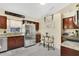 Modern kitchen featuring stainless steel appliances, a breakfast table, and granite countertops at 906 Elm Forest Dr, Minneola, FL 34715