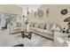 Bright living room with a large sectional couch, decorative rug, and stylish decor elements at 906 Elm Forest Dr, Minneola, FL 34715