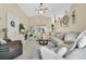 Inviting living room featuring a comfortable sectional sofa, ceiling fan, and elegant decorations at 906 Elm Forest Dr, Minneola, FL 34715