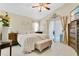 Serene main bedroom featuring a ceiling fan, neutral decor, and sliding glass doors to the patio at 906 Elm Forest Dr, Minneola, FL 34715