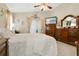 Tranquil main bedroom with a ceiling fan, elegant decor, and a view of the outdoors at 906 Elm Forest Dr, Minneola, FL 34715