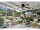 Cozy covered patio featuring comfortable seating and views of the spacious, well-maintained backyard at 906 Elm Forest Dr, Minneola, FL 34715