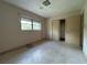 Neutral bedroom features a window for natural light and closet for storage at 930 Aultman Rd, Kissimmee, FL 34744