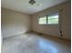 A simple bedroom features a window, terrazzo floors and potential for customization at 930 Aultman Rd, Kissimmee, FL 34744