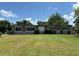 A single-story brick home featuring white-trimmed windows and manicured bushes at 930 Aultman Rd, Kissimmee, FL 34744