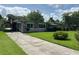 Charming single-story home featuring a well-maintained lawn and long driveway at 930 Aultman Rd, Kissimmee, FL 34744