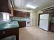 Spacious kitchen featuring vintage appliances and ample cabinet space at 930 Aultman Rd, Kissimmee, FL 34744