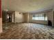 Bright living room features large window for natural light and classic wall-to-wall carpeting at 930 Aultman Rd, Kissimmee, FL 34744