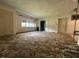 Spacious living room featuring large windows and sliding glass doors, ready for renovation at 930 Aultman Rd, Kissimmee, FL 34744
