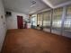 Screened porch featuring a door, windows, ceiling fan, and laundry equipment at 930 Aultman Rd, Kissimmee, FL 34744