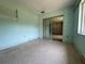 The room features terrazzo flooring, light-blue painted walls, and a sliding glass door leading to another room at 930 Aultman Rd, Kissimmee, FL 34744