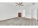 Bedroom featuring a ceiling fan, plush carpeting, wooden dresser and open entryway to ensuite at 983 Silverlake Blvd, Lake Alfred, FL 33850