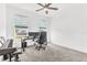 Bedroom featuring a ceiling fan, plush carpeting, work desk and natural light filtering through the window at 983 Silverlake Blvd, Lake Alfred, FL 33850