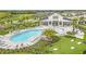 Aerial view of community pool and entertaining space with lush landscaping, tables and lounge chairs at 983 Silverlake Blvd, Lake Alfred, FL 33850