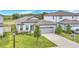 Beautiful single-Gathering home with a two-car garage, blue front door, and landscaped front yard at 983 Silverlake Blvd, Lake Alfred, FL 33850