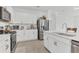 Beautiful kitchen with white cabinets, stainless steel appliances, and ample counter space at 983 Silverlake Blvd, Lake Alfred, FL 33850