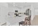 Bright kitchen boasting a center island, white cabinets, and stainless steel appliances for a modern look at 983 Silverlake Blvd, Lake Alfred, FL 33850