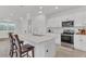 Modern kitchen featuring white cabinetry, stainless steel appliances, and a large center island with seating at 983 Silverlake Blvd, Lake Alfred, FL 33850