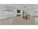 Spacious living room with tile flooring, a ceiling fan, and sliding glass doors leading to the outdoor area at 983 Silverlake Blvd, Lake Alfred, FL 33850