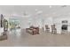 Open concept living area with a kitchen island, leather sofa, and sliding glass doors to the backyard at 983 Silverlake Blvd, Lake Alfred, FL 33850