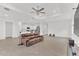 Spacious living room featuring tile flooring and open to the kitchen, perfect for entertaining and Gathering gatherings at 983 Silverlake Blvd, Lake Alfred, FL 33850