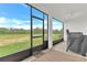 Enjoy the screened patio overlooking a beautiful green space, complete with a ceiling fan and outdoor grill at 983 Silverlake Blvd, Lake Alfred, FL 33850