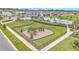 Community playground is fenced for safety with black metal and has ample room for playing games at 983 Silverlake Blvd, Lake Alfred, FL 33850