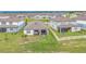 Aerial view of a house showing a screened patio and lawn, along with neighboring homes at 983 Silverlake Blvd, Lake Alfred, FL 33850