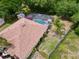 An aerial view showcasing a screened pool and patio area in the backyard at 1011 Dampierre Ct, Kissimmee, FL 34759
