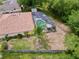 Aerial view of backyard with screened pool, patio, and a fenced yard at 1011 Dampierre Ct, Kissimmee, FL 34759