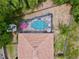 An aerial view shows the roof and screened pool and yard with storage building at 1011 Dampierre Ct, Kissimmee, FL 34759