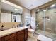 This bathroom features a stylish glass shower, a large mirror, and updated vanity at 1011 Dampierre Ct, Kissimmee, FL 34759