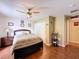 Bright and spacious bedroom offering a bed, dark wood floors, and bright natural lighting at 1011 Dampierre Ct, Kissimmee, FL 34759