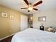 Bedroom featuring a white comforter, closet, a ceiling fan, and wooden floors, creating a calm and inviting atmosphere at 1011 Dampierre Ct, Kissimmee, FL 34759