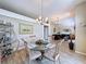 This dining room features a glass-top table with seating for four and decorative touches at 1011 Dampierre Ct, Kissimmee, FL 34759