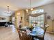 The dining room is open to the living area with a glass-top table and plenty of natural light at 1011 Dampierre Ct, Kissimmee, FL 34759