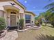 Inviting front entrance with decorative landscaping and a charming front door at 1011 Dampierre Ct, Kissimmee, FL 34759