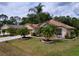 An eye-level view of single-story house with a large front yard and palm trees at 1011 Dampierre Ct, Kissimmee, FL 34759
