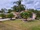 Attractive home exterior with a lush lawn and decorative palm trees at 1011 Dampierre Ct, Kissimmee, FL 34759