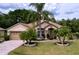Inviting single-Gathering home with a well-maintained lawn and beautiful landscaping at 1011 Dampierre Ct, Kissimmee, FL 34759