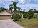 Charming home featuring a well-manicured lawn, mature palm trees, and a decorative driveway at 1011 Dampierre Ct, Kissimmee, FL 34759