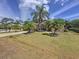 Lovely home with lush green lawn, mature palm trees, and a well-kept facade at 1011 Dampierre Ct, Kissimmee, FL 34759
