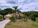Well-maintained home featuring a lush lawn, mature landscaping, and an inviting facade at 1011 Dampierre Ct, Kissimmee, FL 34759