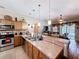 Spacious kitchen with stainless steel appliances, wooden cabinets, and breakfast bar seating at 1011 Dampierre Ct, Kissimmee, FL 34759