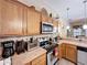Well-equipped kitchen featuring stainless steel appliances, wooden cabinetry, and decorative backsplash at 1011 Dampierre Ct, Kissimmee, FL 34759
