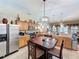 Open kitchen featuring stainless steel appliances, a breakfast bar, and an adjacent dining area at 1011 Dampierre Ct, Kissimmee, FL 34759