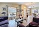 Comfortable living room open to the dining area, featuring a modern glass coffee table at 1011 Dampierre Ct, Kissimmee, FL 34759