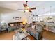 A well-lit living room with hardwood floors leads to a breakfast bar and kitchen at 1011 Dampierre Ct, Kissimmee, FL 34759
