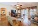 Cozy living room featuring a fireplace, wood floors, large windows and sliding glass door with backyard view at 1011 Dampierre Ct, Kissimmee, FL 34759